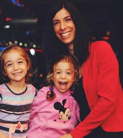 Early photo of Nadine Ismiel-Nash smiling with her two daughters